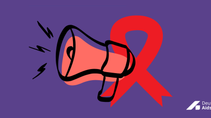 Megafon und rote Schleife